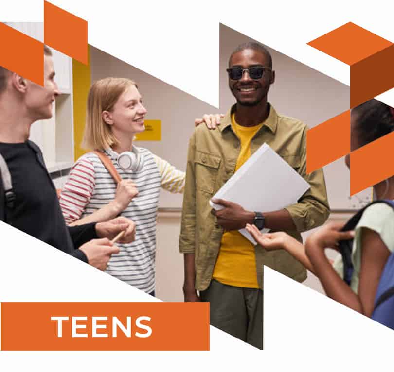 Teenage blind male in hallway with friends.